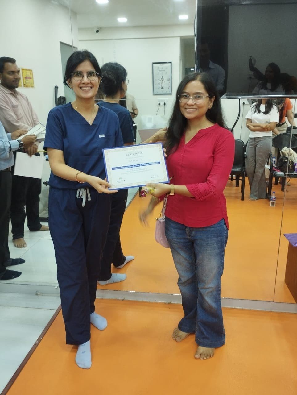 Dr. Neha Shukla presenting certificate — graduate 1