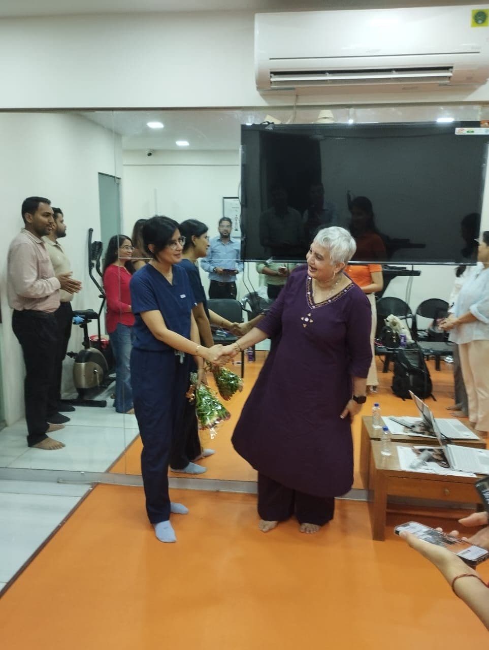 Dr. Neha Shukla presenting certificate — graduate 10