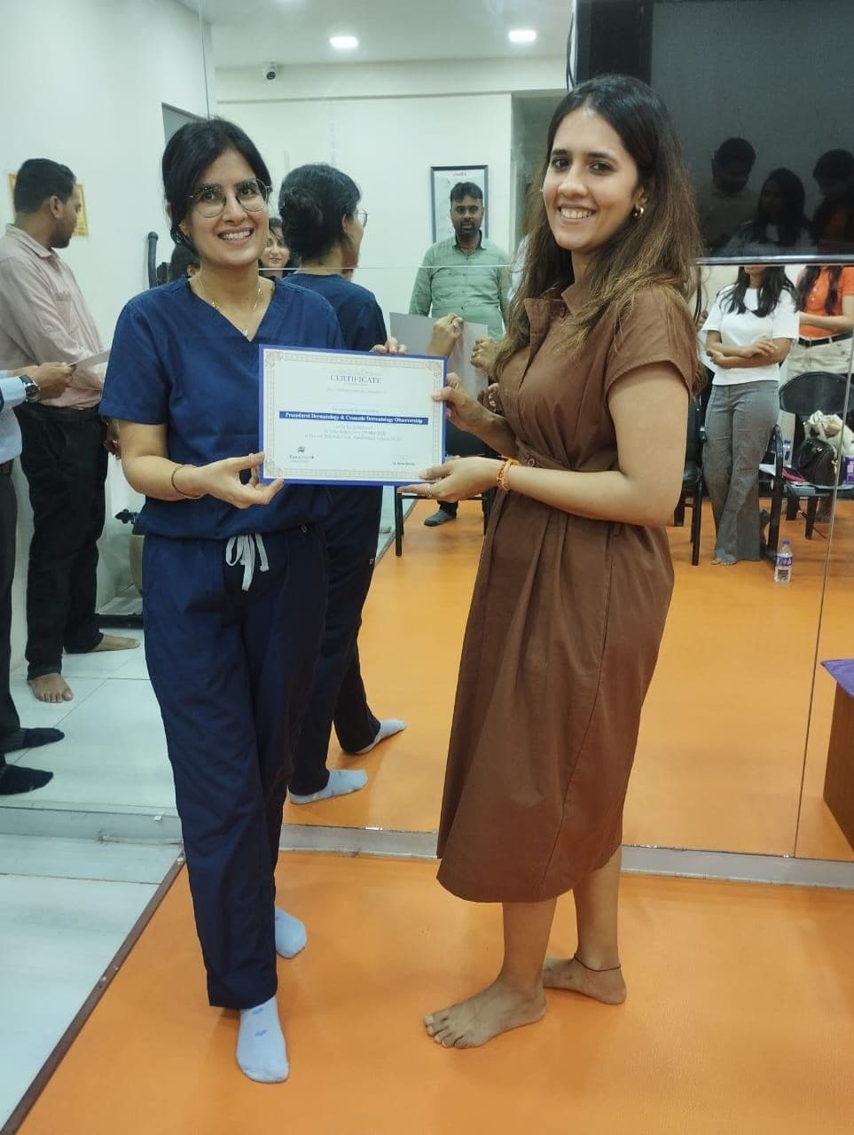 Dr. Neha Shukla presenting certificate — graduate 11