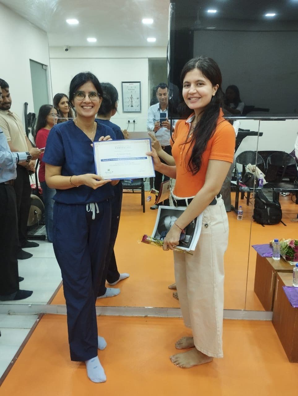 Dr. Neha Shukla presenting certificate — graduate 13