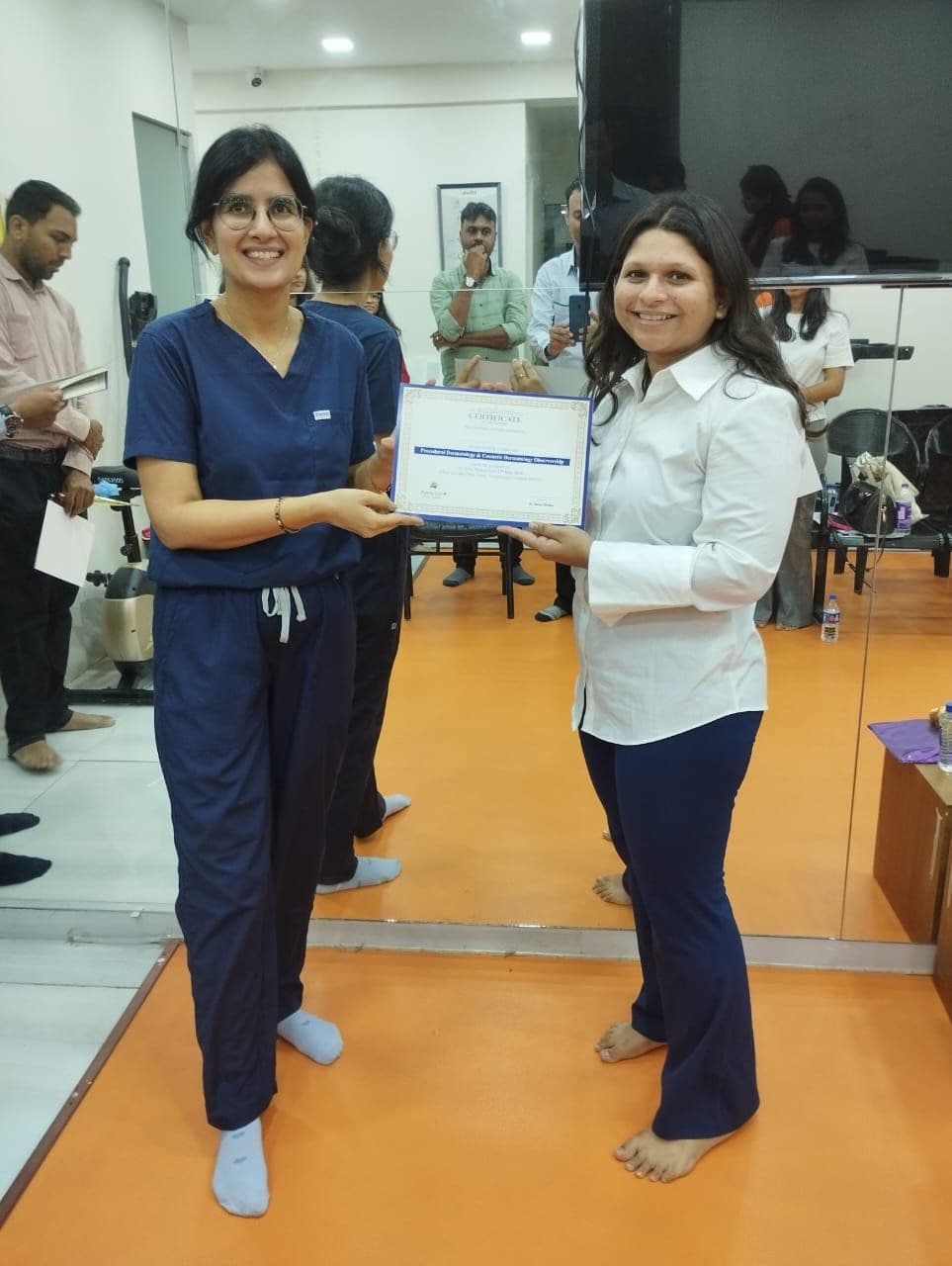 Dr. Neha Shukla presenting certificate — graduate 14