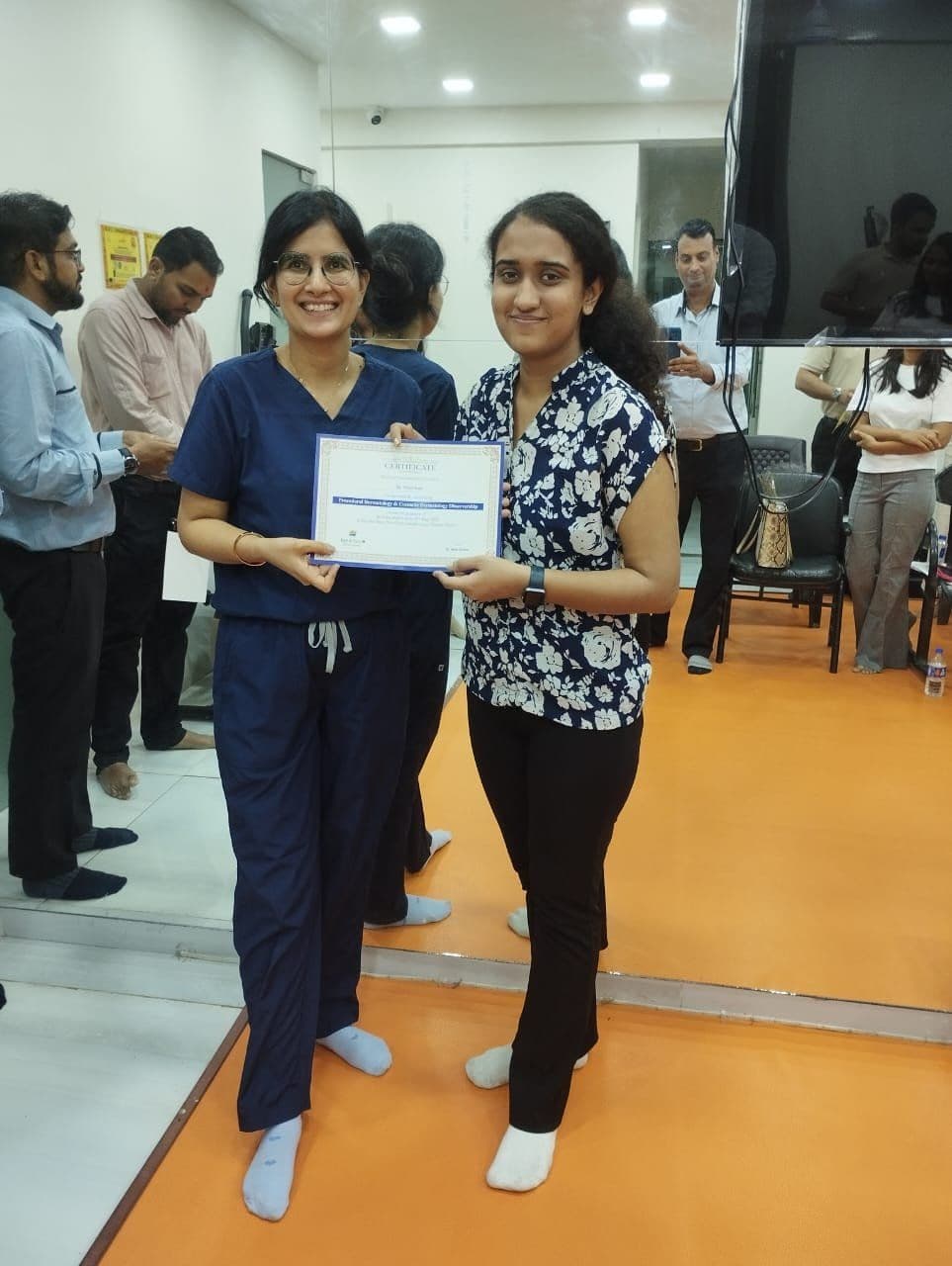 Dr. Neha Shukla presenting certificate — graduate 15