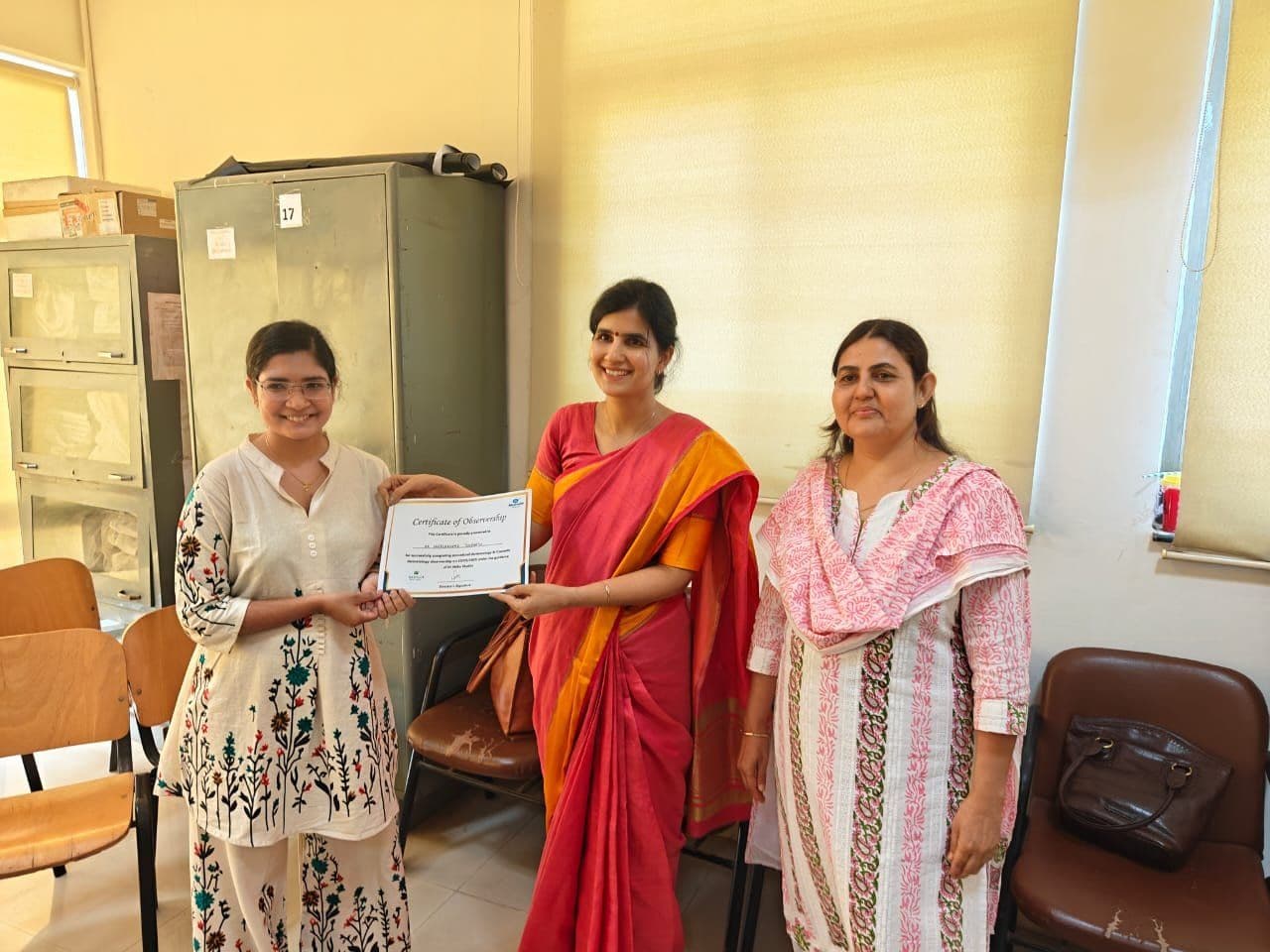 Dr. Neha Shukla presenting certificate — graduate 22