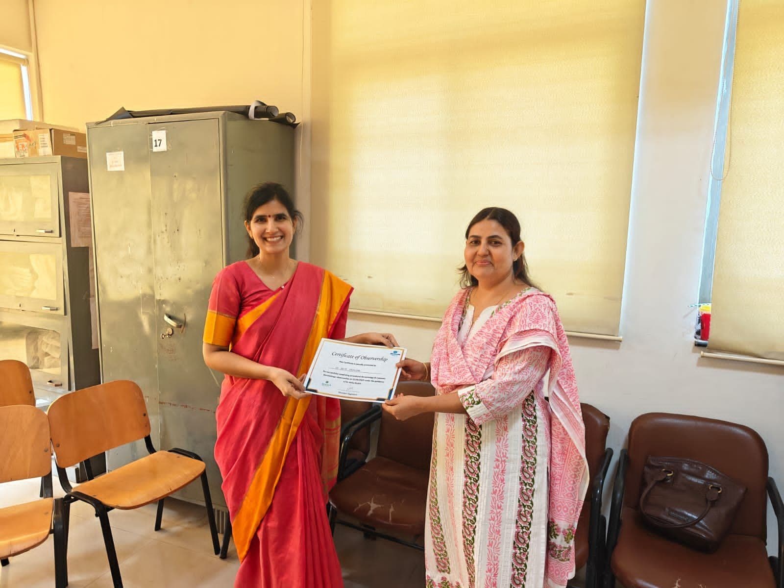 Dr. Neha Shukla presenting certificate — graduate 23