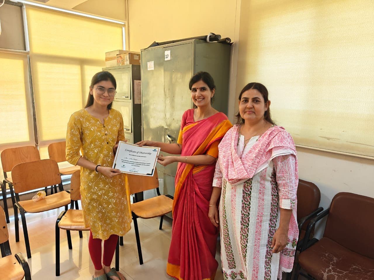 Dr. Neha Shukla presenting certificate — graduate 27