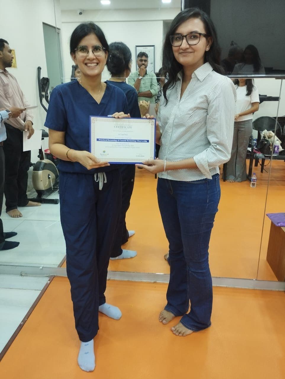Dr. Neha Shukla presenting certificate — graduate 3