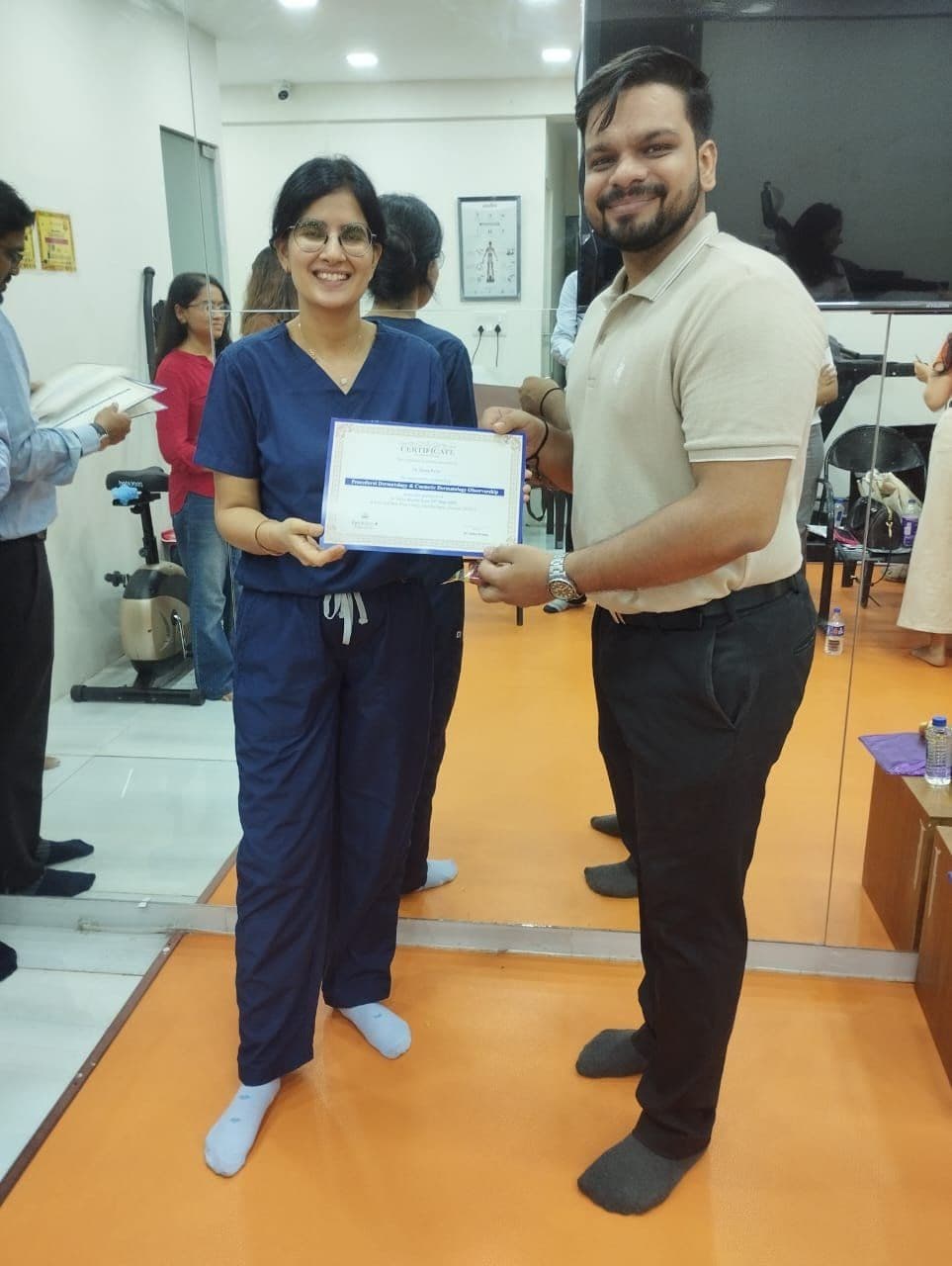 Dr. Neha Shukla presenting certificate — graduate 4