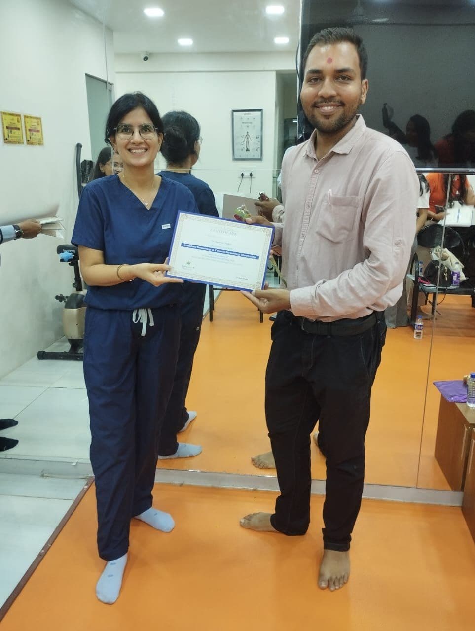 Dr. Neha Shukla presenting certificate — graduate 5